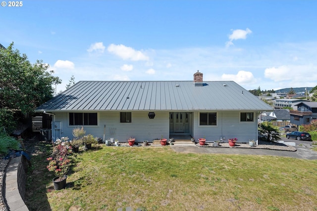 2144 Hamilton St, North Bend, OR 97459 - back of house featuring a lawn, a chimney, metal roof, and a standing seam roof