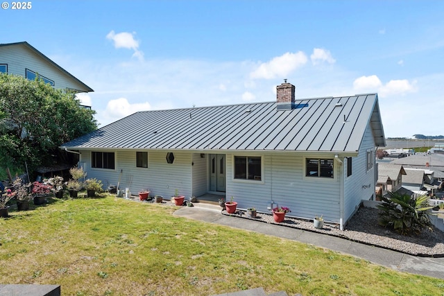 2144 Hamilton St, North Bend, OR 97459 - rear view of house with a standing seam roof, a chimney, metal roof, and a yard