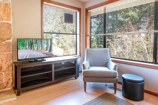 living area with hardwood / wood-style flooring