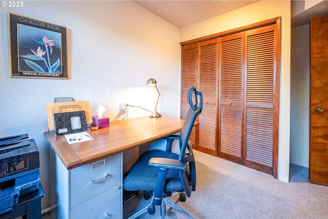 home office featuring carpet floors and a textured ceiling