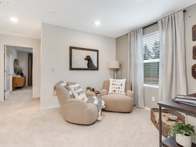 sitting room featuring light carpet