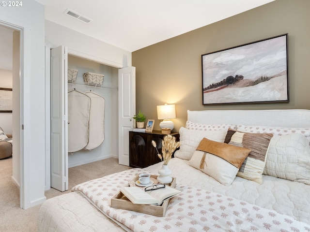 bedroom with light colored carpet and a closet