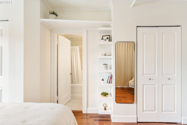 1005 SW Park Ave Unit 607, Portland, OR 97205 - bedroom with wood finished floors, ornamental molding, and a closet