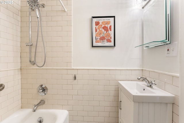 1005 SW Park Ave Unit 607, Portland, OR 97205 - bathroom with tub / shower combination, vanity, a wainscoted wall, and tile walls