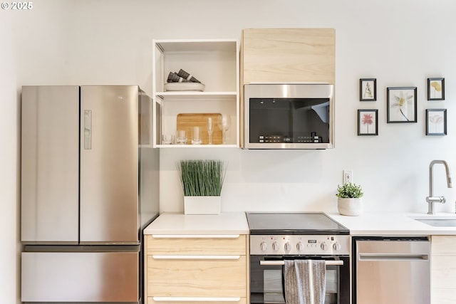 1005 SW Park Ave Unit 607, Portland, OR 97205 - kitchen with appliances with stainless steel finishes, light countertops, a sink, and light brown cabinets