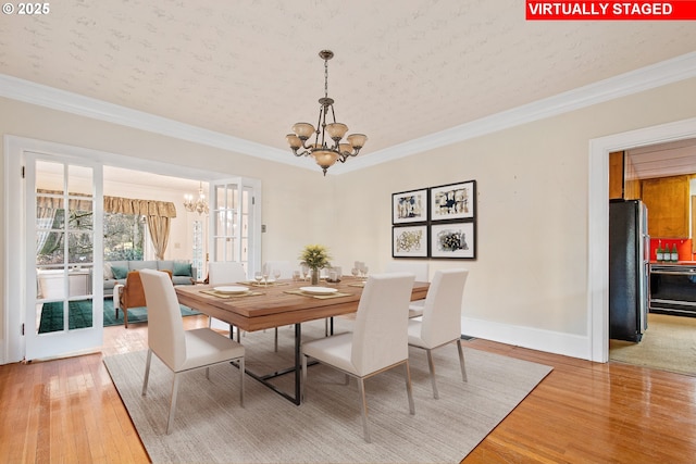 dining space with hardwood / wood-style flooring, a notable chandelier, ornamental molding, and a textured ceiling