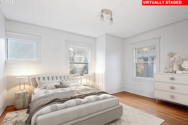 bedroom featuring hardwood / wood-style floors and a textured ceiling