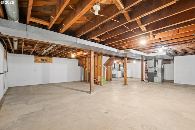 basement with heating unit and separate washer and dryer