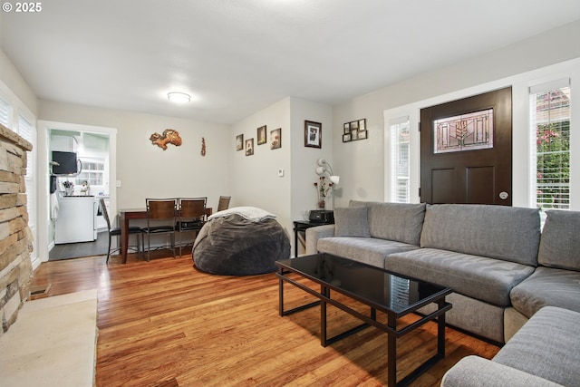 8535 SW Oleson Rd, Portland, OR 97223 - living room with washer / dryer, light wood-style floors, and visible vents