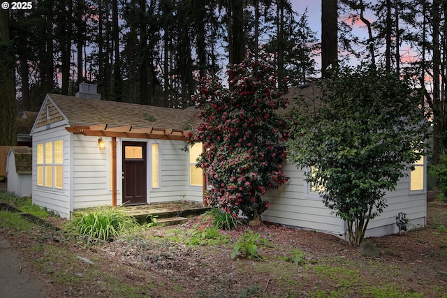 8535 SW Oleson Rd, Portland, OR 97223 - view of front of property featuring a shingled roof and a chimney