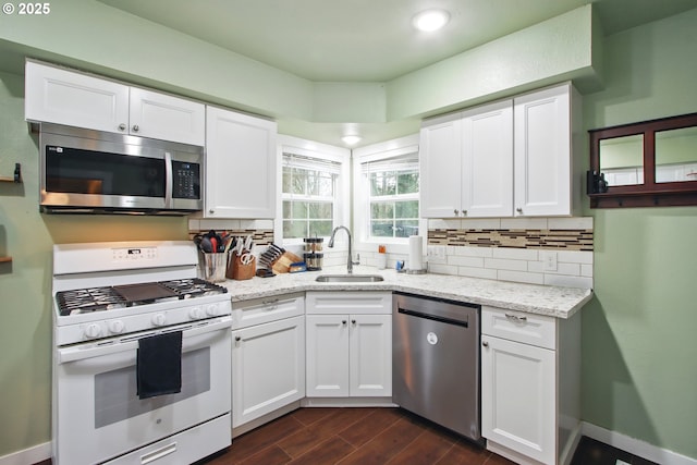 8535 SW Oleson Rd, Portland, OR 97223 - kitchen featuring a sink, white cabinets, tasteful backsplash, appliances with stainless steel finishes, and dark wood-style floors
