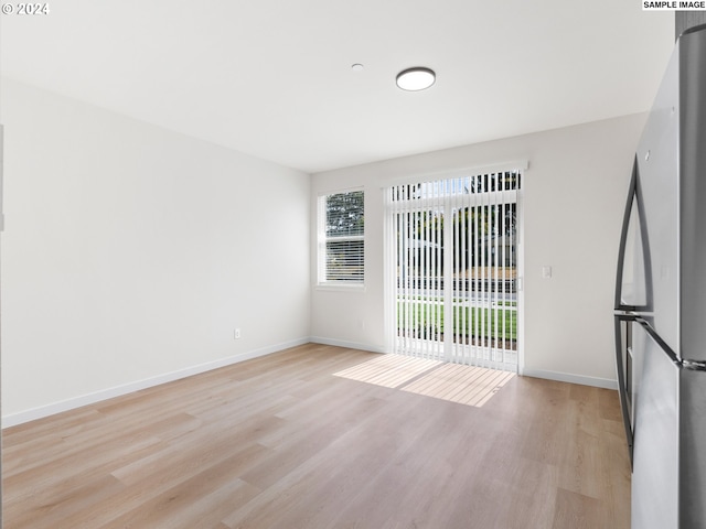 empty room with light hardwood / wood-style floors