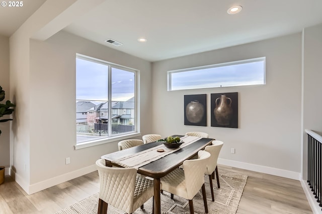 dining area featuring light wood-style flooring, recessed lighting, visible vents, and baseboards