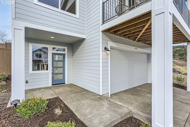 entrance to property featuring an attached garage