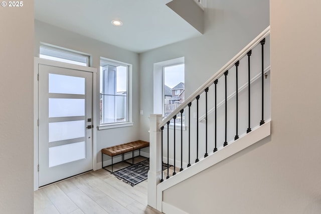 entrance foyer with stairs and recessed lighting