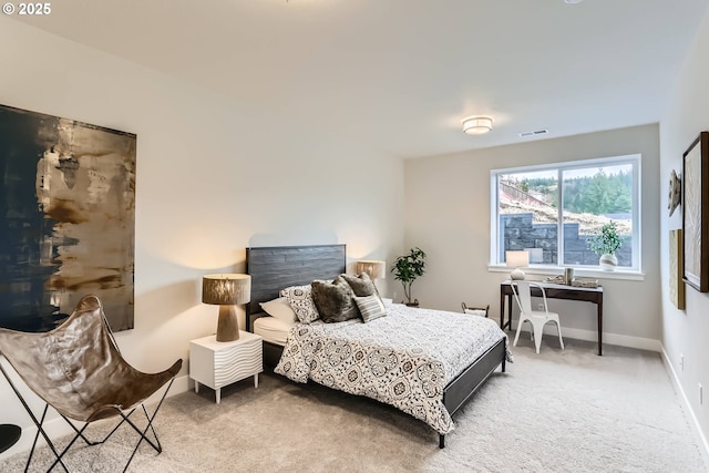 carpeted bedroom featuring visible vents and baseboards