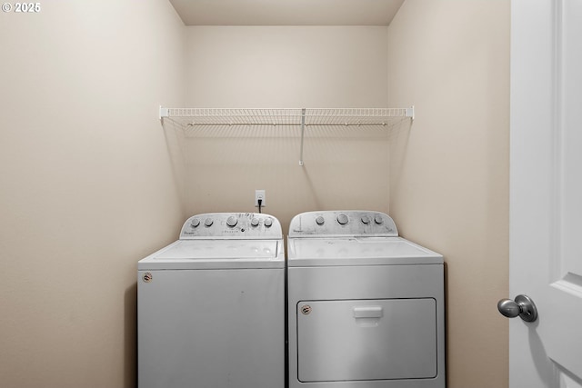 laundry room featuring washing machine and clothes dryer