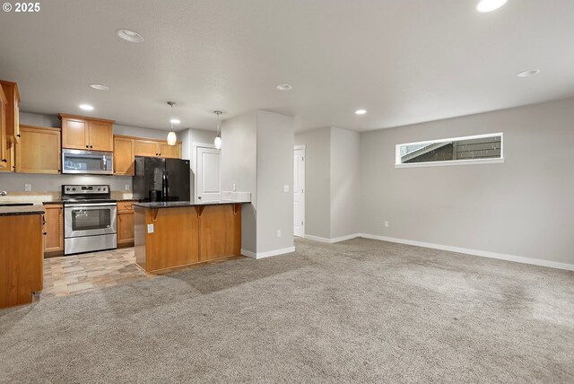 kitchen with a breakfast bar, appliances with stainless steel finishes, a kitchen island, light carpet, and decorative light fixtures