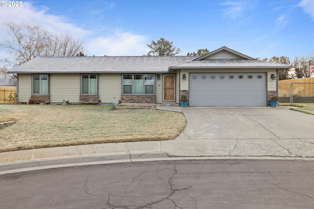 single story home with a front yard and a garage