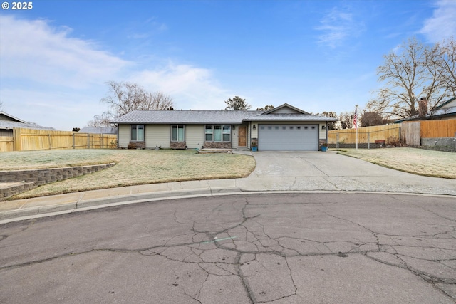 single story home featuring a front yard and a garage