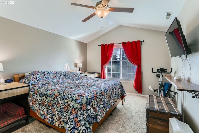 carpeted bedroom with ceiling fan and vaulted ceiling