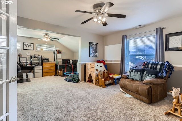 living room featuring carpet flooring, ceiling fan, and vaulted ceiling