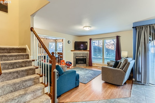 living room featuring light tile patterned floors and a tiled fireplace