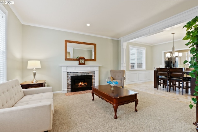 16041 NW Trakehner Way, Portland, OR 97229 - carpeted living area with a chandelier, ornamental molding, a brick fireplace, and recessed lighting