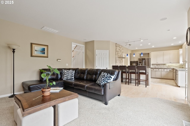 16041 NW Trakehner Way, Portland, OR 97229 - living area featuring rail lighting, light colored carpet, and baseboards