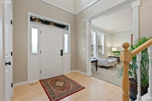16041 NW Trakehner Way, Portland, OR 97229 - foyer entrance featuring light wood-style flooring, crown molding, baseboards, and decorative columns