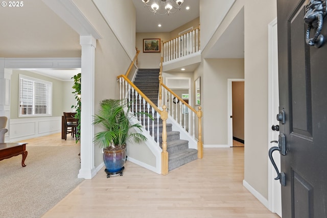 16041 NW Trakehner Way, Portland, OR 97229 - foyer with wood finished floors, stairway, a chandelier, baseboards, and recessed lighting