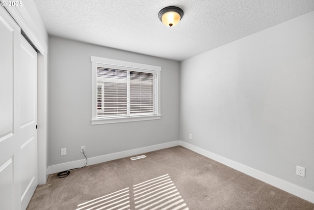 16849 SW Friendly Ln, Beaverton, OR 97007 - unfurnished bedroom featuring carpet, a closet, a textured ceiling, and baseboards