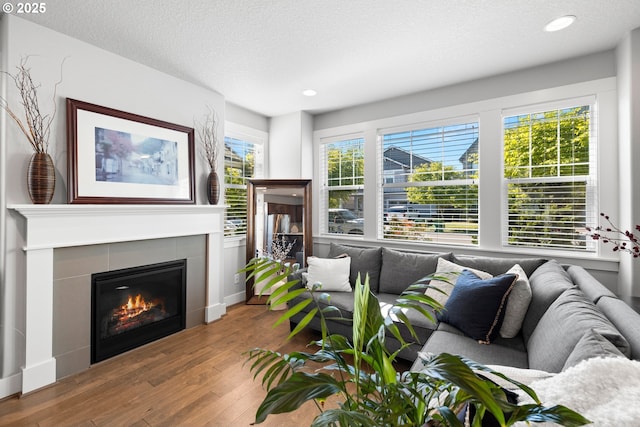 16849 SW Friendly Ln, Beaverton, OR 97007 - living room with wood finished floors, a fireplace, recessed lighting, and a textured ceiling