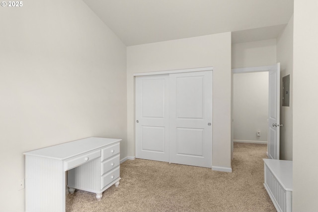 1020 SW 170th Ave Unit 203, Beaverton, OR 97003 - unfurnished bedroom featuring light colored carpet, electric panel, baseboards, a closet, and vaulted ceiling