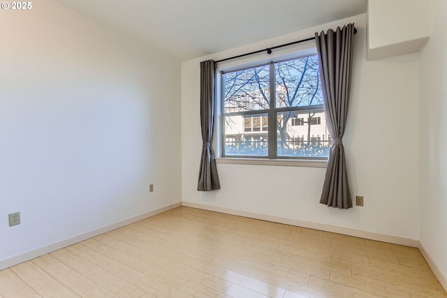 unfurnished room with light wood-type flooring