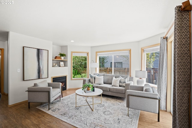 6309 NE 45th Ave, Portland, OR 97218 - living area featuring healthy amount of natural light, wood finished floors, a lit fireplace, baseboards, and recessed lighting