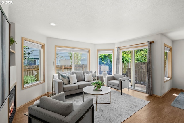 6309 NE 45th Ave, Portland, OR 97218 - living room featuring a textured ceiling, baseboards, wood finished floors, and recessed lighting