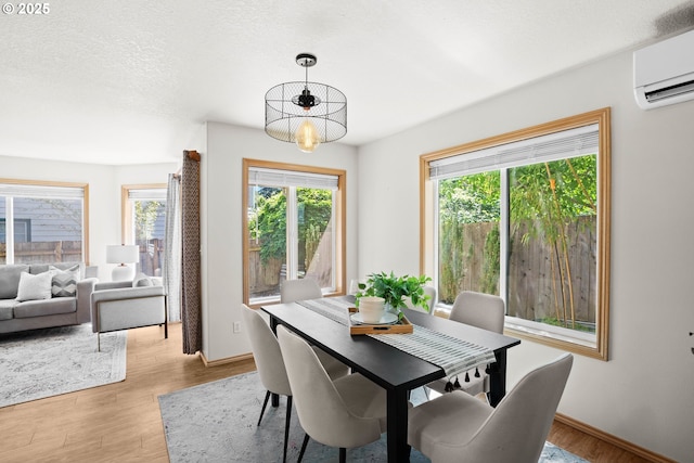 6309 NE 45th Ave, Portland, OR 97218 - dining area with a wall mounted air conditioner, light wood finished floors, and baseboards