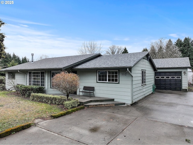 ranch-style house featuring concrete driveway and a shingled roof