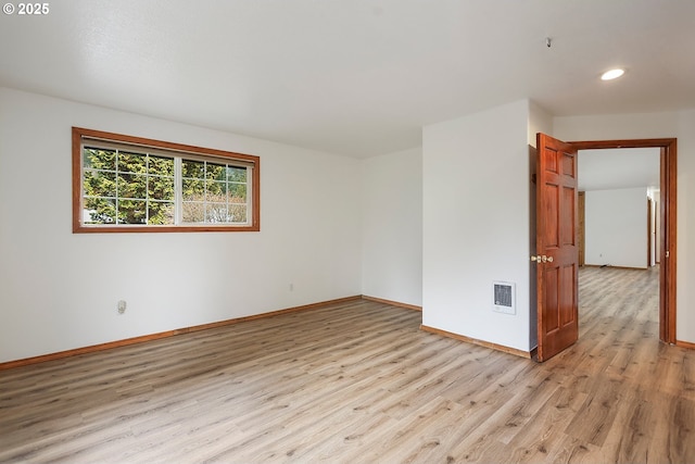 unfurnished room with visible vents, baseboards, and light wood finished floors