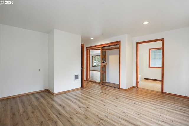 empty room with recessed lighting, visible vents, light wood-style flooring, and baseboards