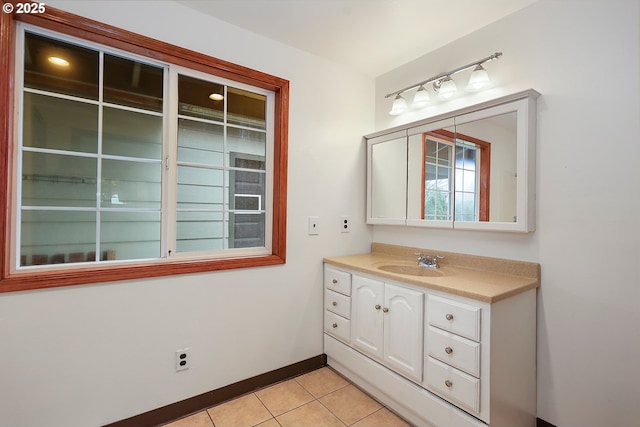 bathroom featuring tile patterned floors, baseboards, and vanity