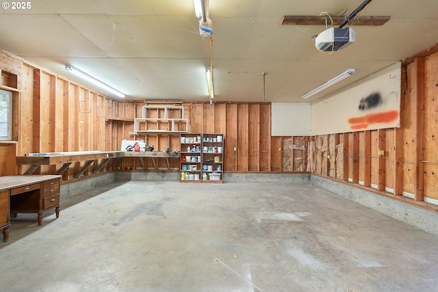 garage with a workshop area and a garage door opener