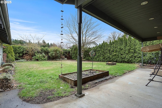 view of yard featuring a fire pit, a patio, and a garden