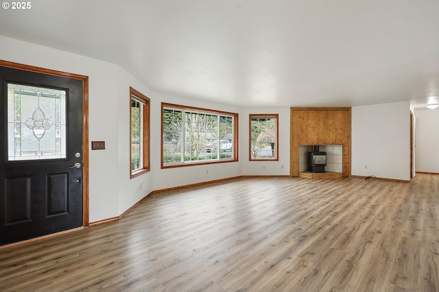 unfurnished living room with light wood finished floors and baseboards