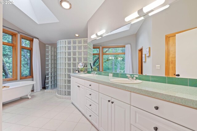 18020 SE 370th Ave, Sandy, OR 97055 - full bathroom featuring a skylight, lofted ceiling, tile patterned floors, double vanity, and a freestanding tub