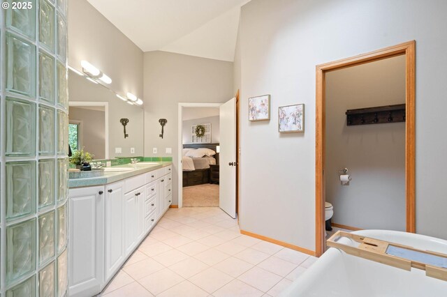 18020 SE 370th Ave, Sandy, OR 97055 - ensuite bathroom with double vanity, a freestanding bath, toilet, tile patterned floors, and lofted ceiling
