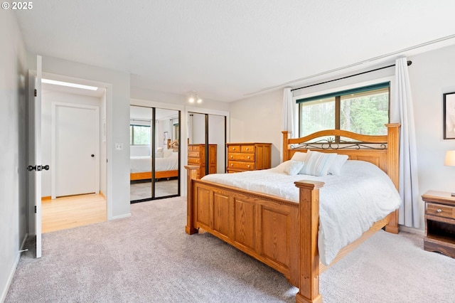18020 SE 370th Ave, Sandy, OR 97055 - bedroom featuring light colored carpet, two closets, and baseboards