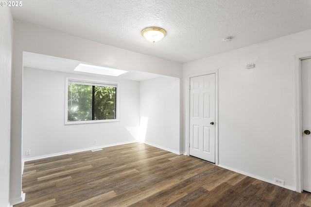 7733 NE Mason St, Portland, OR 97218 - spare room featuring wood finished floors, a smoke detector, and a textured ceiling