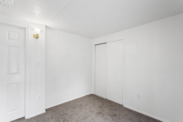 7733 NE Mason St, Portland, OR 97218 - unfurnished bedroom with carpet floors, a textured ceiling, and a closet